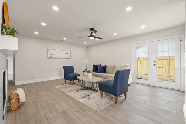 living room with ceiling fan, light wood-type flooring, and french doors