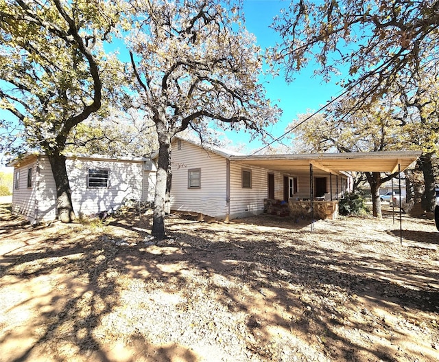 rear view of property with a carport