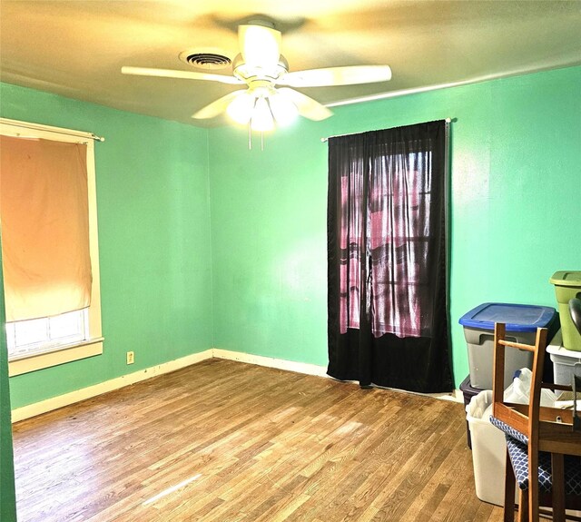 unfurnished room with ceiling fan and wood-type flooring