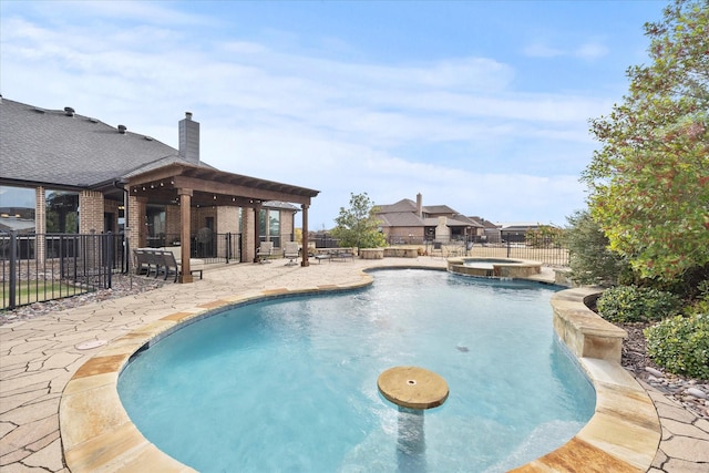 view of pool featuring a patio, fence, and a pool with connected hot tub