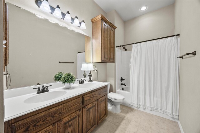 full bathroom featuring toilet, vanity, and shower / bath combo with shower curtain