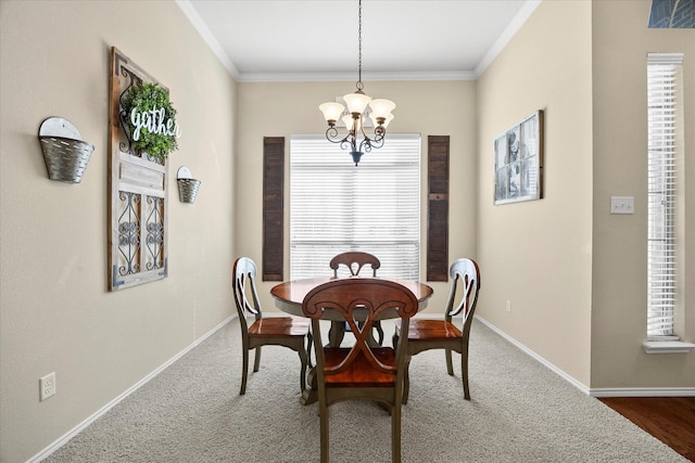 carpeted dining area featuring ornamental molding and a chandelier