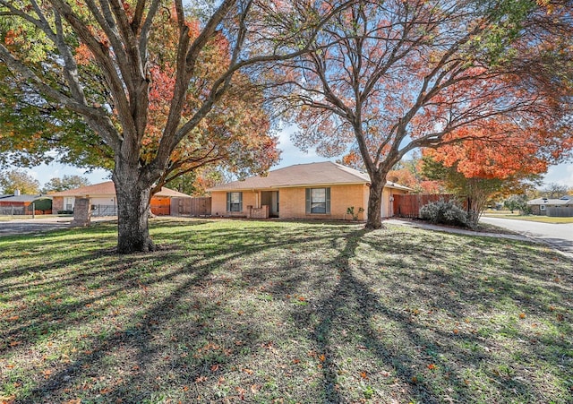 single story home featuring a front lawn