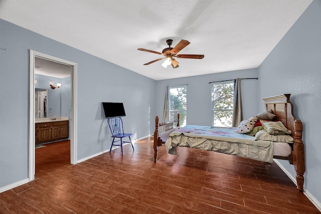 bedroom featuring dark hardwood / wood-style floors, ceiling fan, and ensuite bathroom