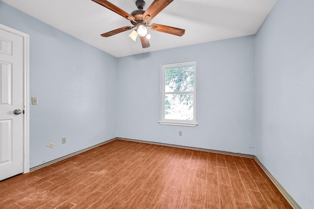 spare room with ceiling fan and light wood-type flooring