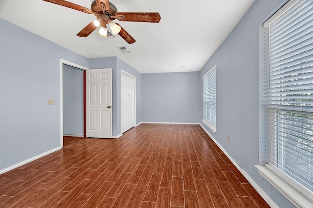 interior space with multiple windows, hardwood / wood-style floors, and ceiling fan