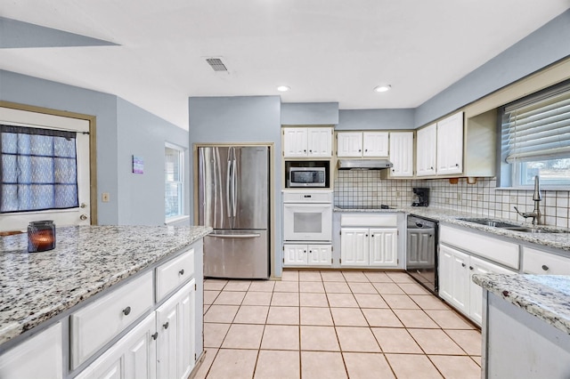 kitchen featuring white cabinets, sink, light stone counters, and black appliances