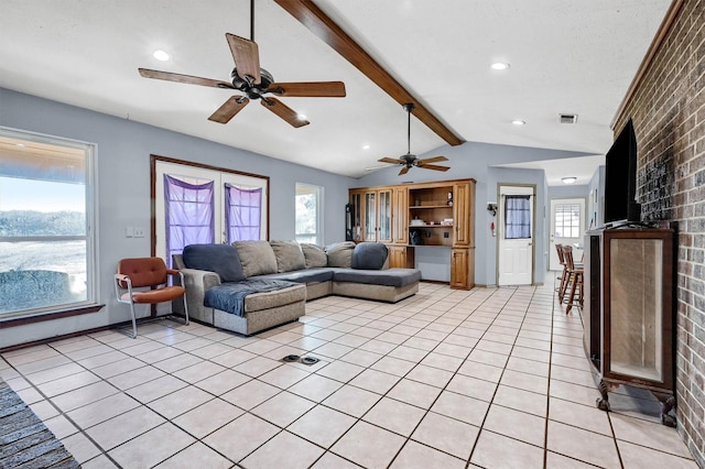 living room featuring vaulted ceiling with beams, plenty of natural light, and brick wall