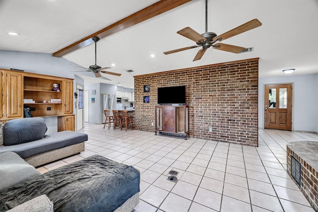 living room with lofted ceiling with beams, light tile patterned flooring, and brick wall