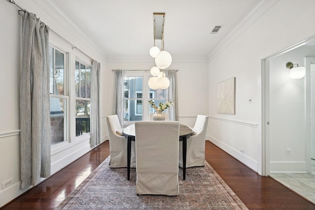 dining space featuring dark hardwood / wood-style flooring and ornamental molding