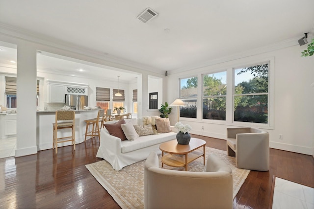 living room featuring hardwood / wood-style flooring and ornamental molding