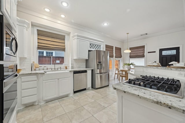 kitchen featuring decorative backsplash, white cabinetry, sink, and appliances with stainless steel finishes