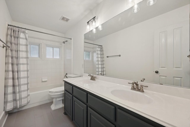 full bathroom featuring shower / tub combo, vanity, and toilet