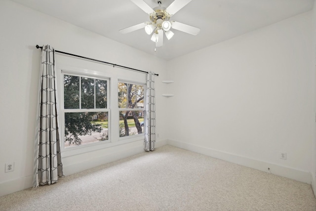 spare room with carpet and ceiling fan