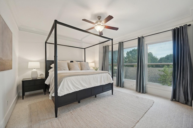 carpeted bedroom with ceiling fan and crown molding