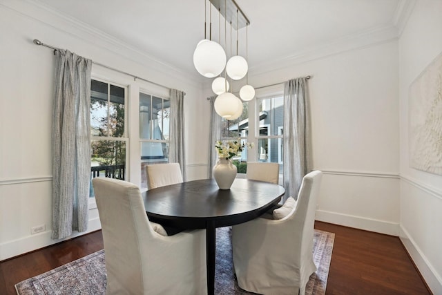 dining space with crown molding, dark wood-type flooring, and a wealth of natural light