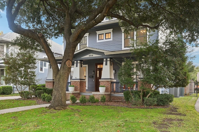 view of front of house featuring a porch and a front lawn