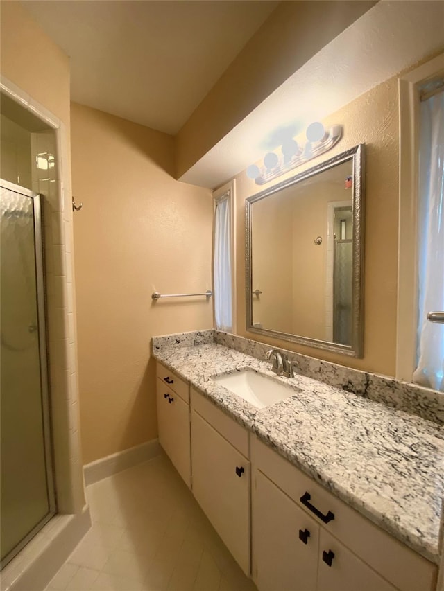 bathroom with vanity, tile patterned floors, and a shower with shower door