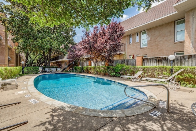 view of swimming pool featuring a patio area