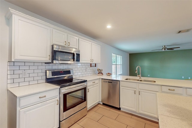 9729 Manassas Rd, Fort Worth, TX 76177 - kitchen with stainless steel appliances, light countertops, tasteful backsplash, ceiling fan, and white cabinetry