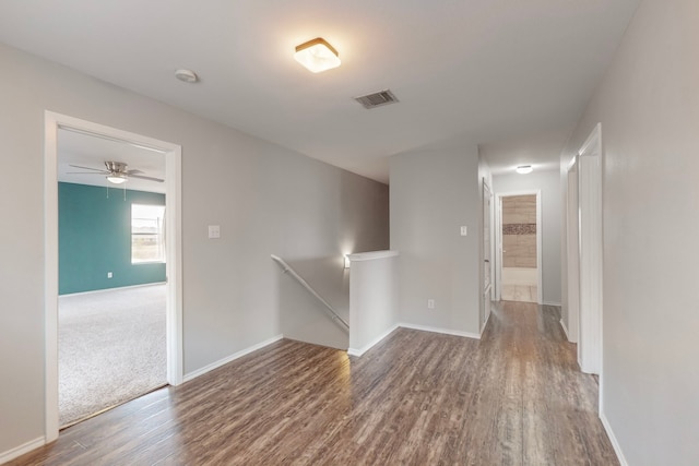 spare room with ceiling fan and wood-type flooring