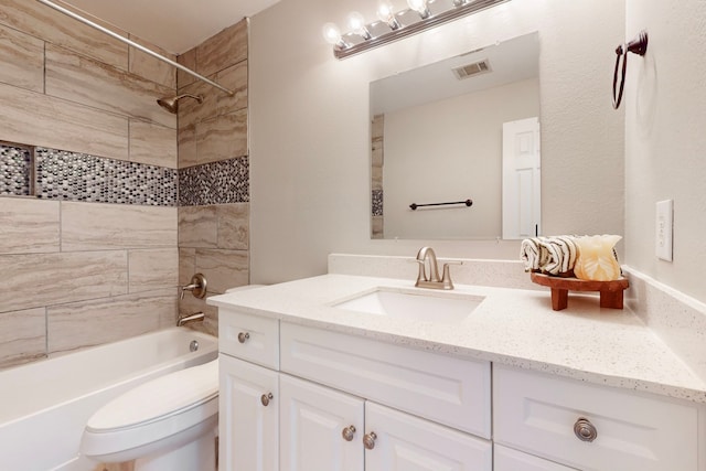 full bathroom with vanity, toilet, and tiled shower / bath