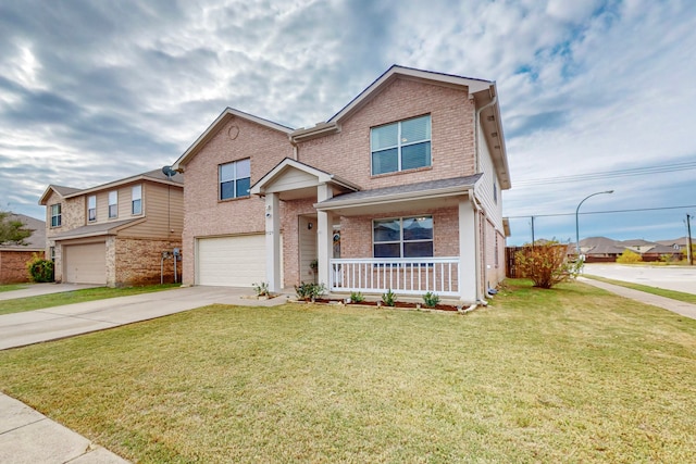 view of front of home featuring a porch, a garage, and a front lawn