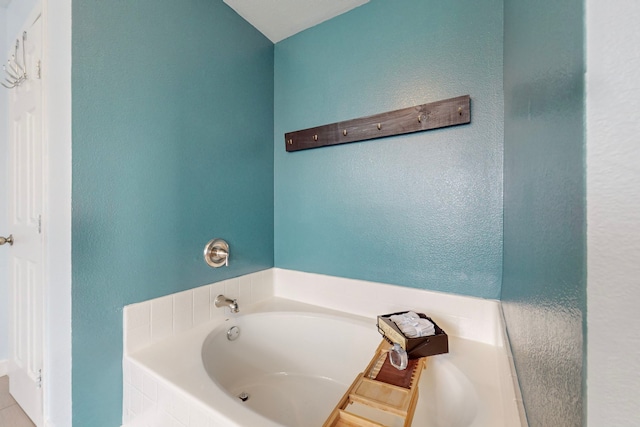 bathroom with a relaxing tiled tub