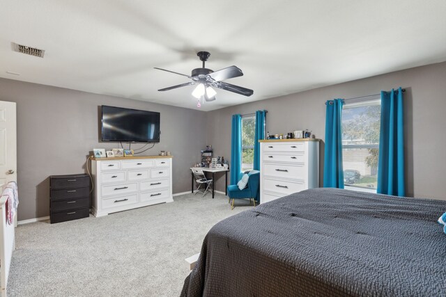 bedroom with light carpet and ceiling fan