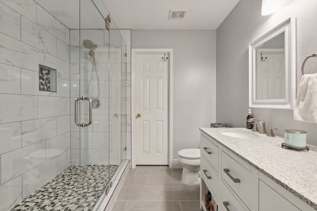 bathroom with vanity, toilet, and an enclosed shower