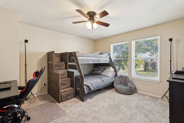 bedroom with ceiling fan and light colored carpet