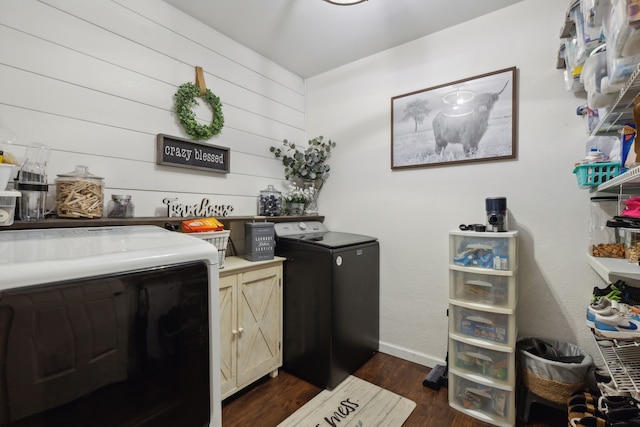 washroom featuring cabinets, washer and dryer, and dark wood-type flooring