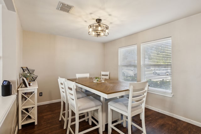 dining room featuring an inviting chandelier and dark hardwood / wood-style floors