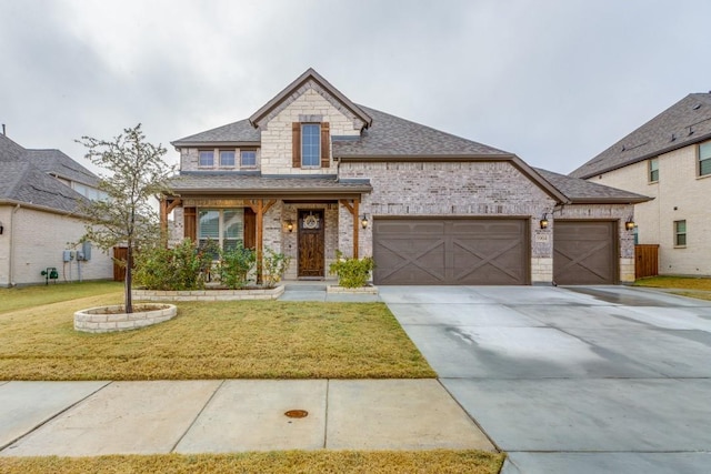 view of front of property featuring a front yard and a garage