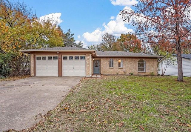 ranch-style home featuring a garage and a front lawn