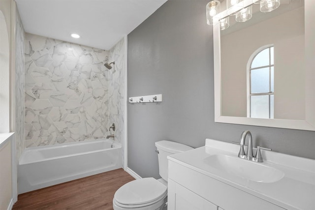 full bathroom featuring vanity, toilet, tiled shower / bath, and hardwood / wood-style flooring