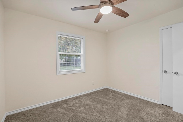 empty room with ceiling fan and carpet floors