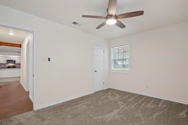 empty room with light carpet and ceiling fan