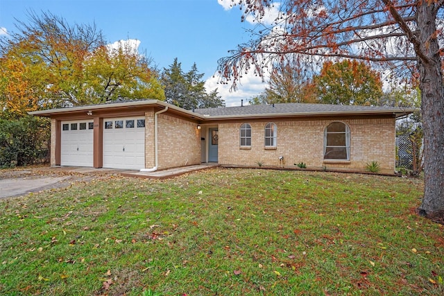 ranch-style home with a garage and a front lawn