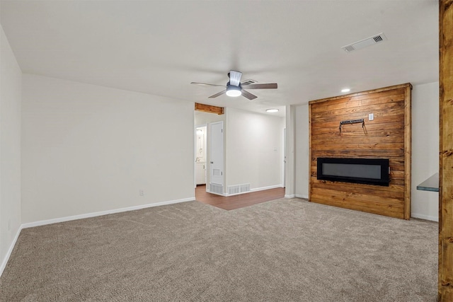 unfurnished living room featuring ceiling fan and carpet floors