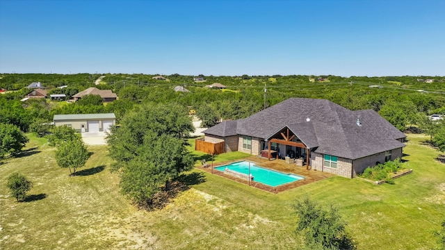 view of pool with a patio area and a lawn