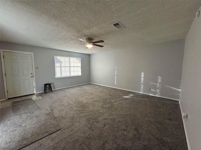 unfurnished room with a textured ceiling, carpet floors, and ceiling fan