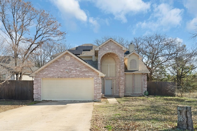 view of front of home featuring a front lawn and solar panels