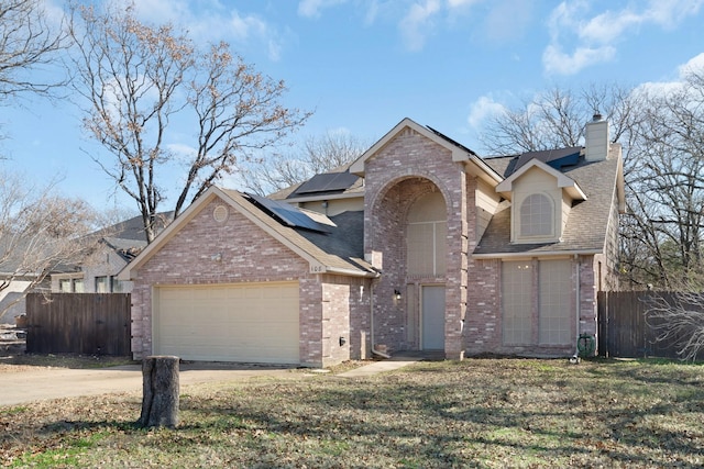 view of front property featuring solar panels and a front yard