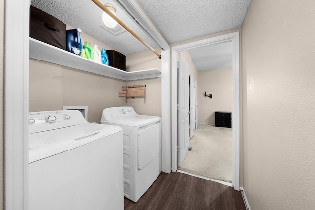 washroom featuring washer and dryer, a textured ceiling, and dark hardwood / wood-style flooring