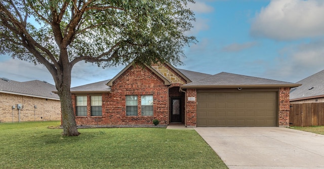 single story home with a garage and a front lawn