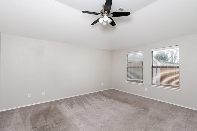 carpeted spare room with ceiling fan