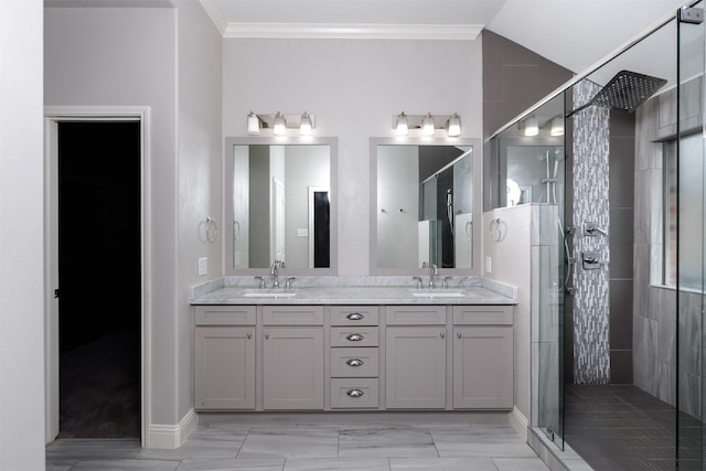 bathroom featuring vanity, a shower with shower door, and ornamental molding