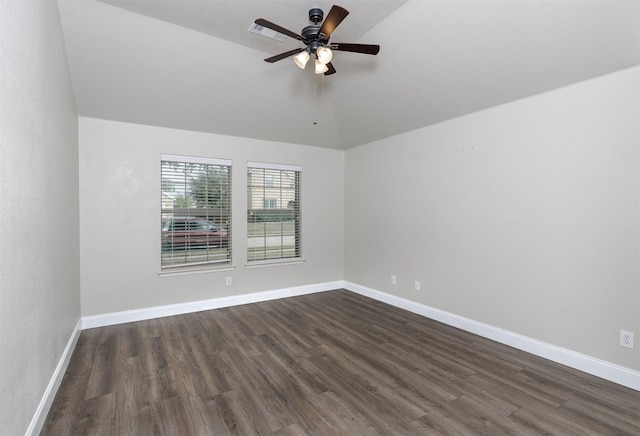 spare room featuring dark hardwood / wood-style floors, ceiling fan, and lofted ceiling