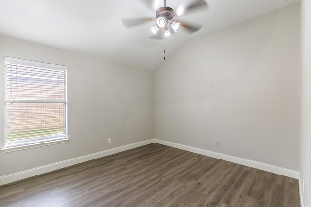 spare room with dark hardwood / wood-style floors, ceiling fan, and vaulted ceiling